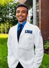 Sumith Liju wearing his white coat.