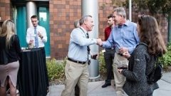 Dental Medicine alumni shake hands.