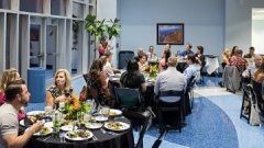 Class of 2013 osteopathic alumni eat dinner at an event.