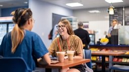 Two students studying in coffee shop.