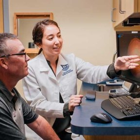 Doctor explains test results to patient at the Arizona Eye Institute.