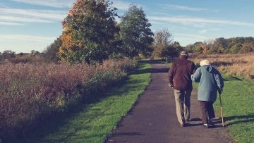 older couple walking in the park