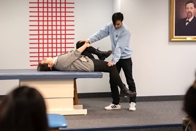 Medical students demonstrate an osteopathic manipulative medicine technique.